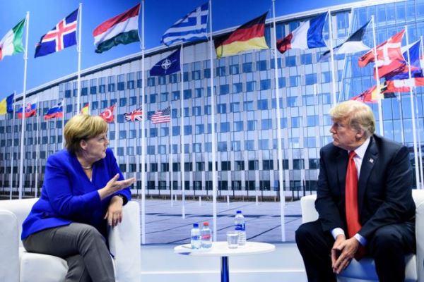 German Chancellor Angela Merkel (L) and US President Donald Trump (R) make a statement to the press after a bilateral meeting on the sidelines of the NATO summit at the NATO headquarters, in Brussels, on July 11, 2018. [Photo: AFP/Brendan Smialowski]