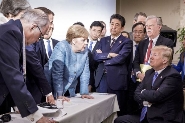 German Chancellor Angela Merkel, center, speaks with U.S. President Donald Trump, seated at right, during the G7 Leaders Summit in La Malbaie, Quebec, Canada, on Saturday, June 9, 2018. [File Photo: AP/Jesco Denzel]