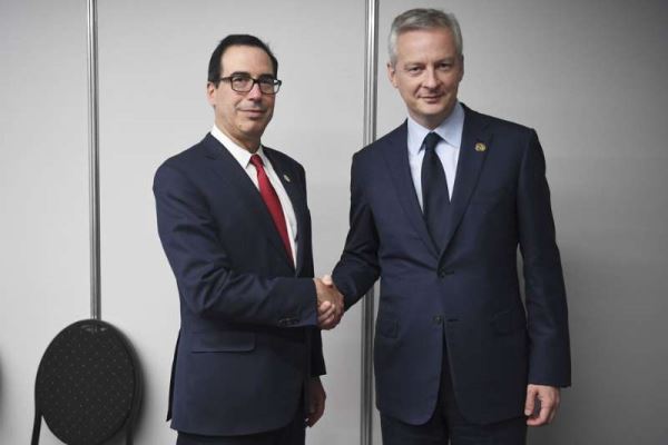 French Finance and Economy Minister Bruno Le Maire (R) shakes hands with US Secretary of the Treasury Steven Mnuchin during a bilateral meeting in Buenos Aires, on July 21, 2018, in the framework of the G20 meeting of Finance Ministers and Central Bank Governors. [Photo: AFP/Eitan Abramovich]
